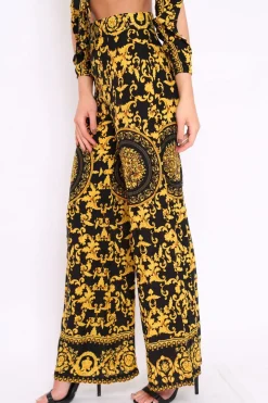 Rebellious Fashion Black and Gold Print High Waist Flare Trousers -Tisha