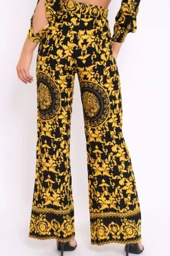 Rebellious Fashion Black and Gold Print High Waist Flare Trousers -Tisha